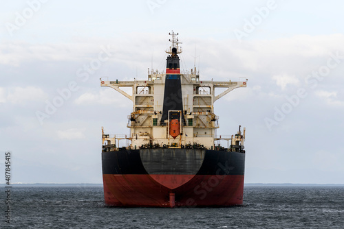 Cargo ship at anchor on the road. Bulk cargo vessel at sea. Logistics import and export business.