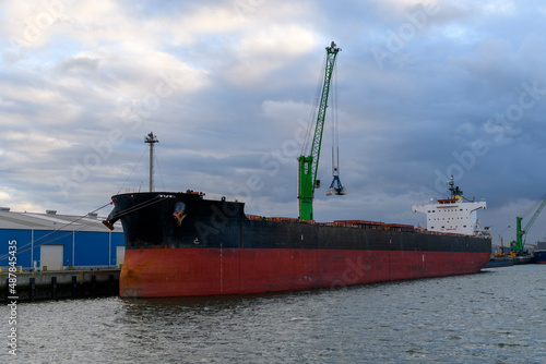 Bulk cargo vessel moored in port. Loading of cargo.