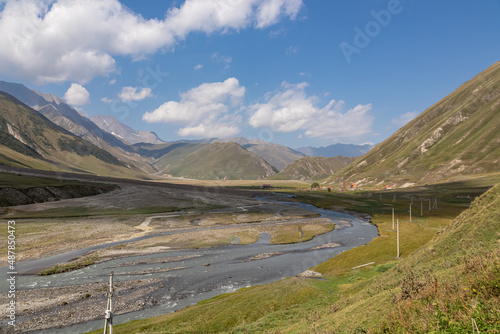 The Terek (Tergi) river flows down the Truso Valley near the Ketrisi Village Kazbegi District,Mtskheta in the Greater Caucasus Mountains,Georgia.Distant view to Zakagori Fortress.Ossetia,Russia border