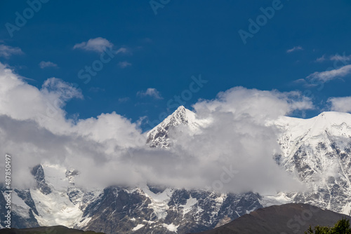 Amazing view from Chubedishi viewpoint on the Shkhara Glacier, near the village Ushguli the Greater Caucasus Mountain Range in Georgia, Svaneti Region. Snow capped mountains covered by clouds.