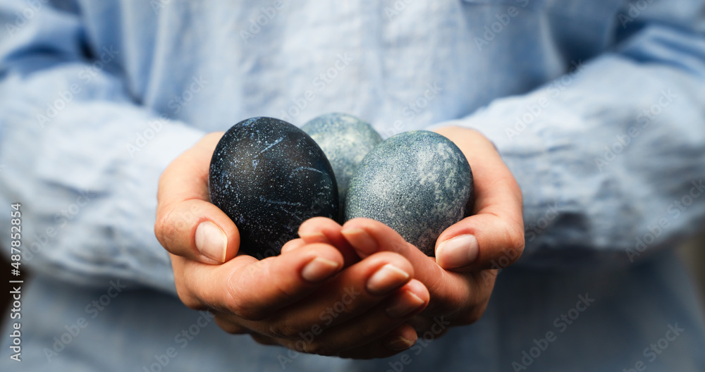 Woman's hands hold painted Easter eggs. Happy Easter. Banner. Close-up. Woman's hands hold painted Easter eggs. Happy Easter. Banner. Close-up.