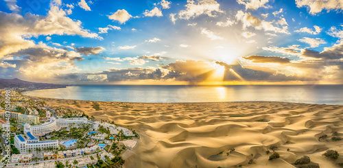 Landscape with Maspalomas town and golden sand dunes at sunrise, Gran Canaria, Canary Islands, Spain photo