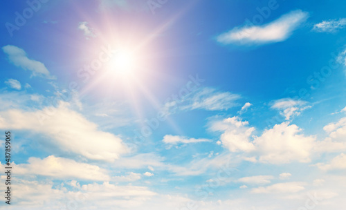 Blue sky, sun and Cumulus clouds.