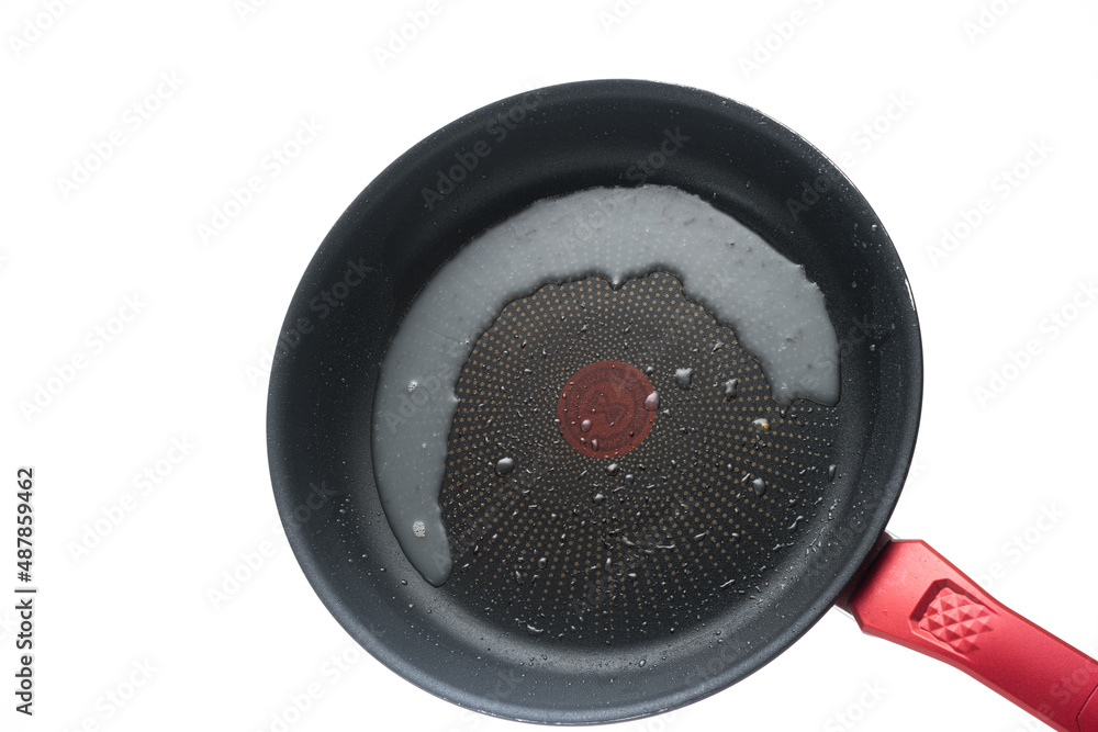Dirty oily burnt metal frying pan or skillet. Close up studio shot, isolated on white background Dirty oily burnt metal frying pan or skillet. Close up studio shot, isolated on white background
