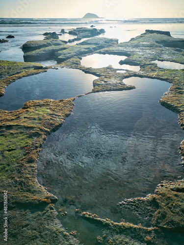 A beautiful shot of a seascape taken in Maukatia Bay, Muriwai, Auckland photo