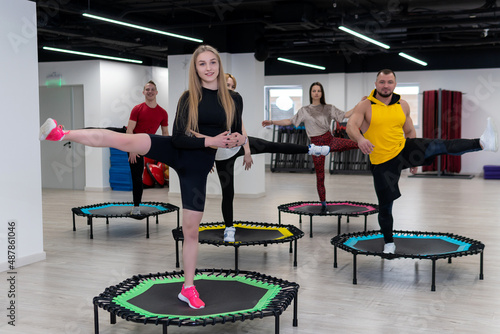 Women's and men's group on a sports trampoline, fitness training, healthy life - a concept trampoline group batut girl healthy, for lifestyle athletic for gym and exercise motion, shape sportswear