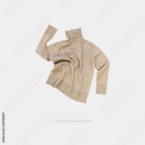 Принти на полотні Flying beige sweater, turtleneck, jumper with high neck isolated on light gray background
