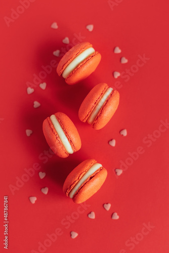 Tasty french macarons on a red background. Concept for Valentine's day.