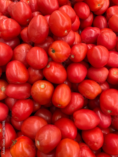 large pile of small red tomatoes