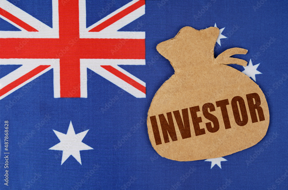 Φωτογραφία On the flag of Australia lies a cardboard figure of a money bag with the inscrip