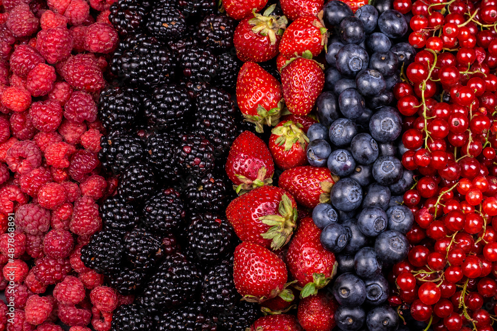Different berry fruits background. Strawberry, blueberry, raspberry, red currant and blackberry mix. Different berry fruits background. Strawberry, blueberry, raspberry, red currant and blackberry mix.