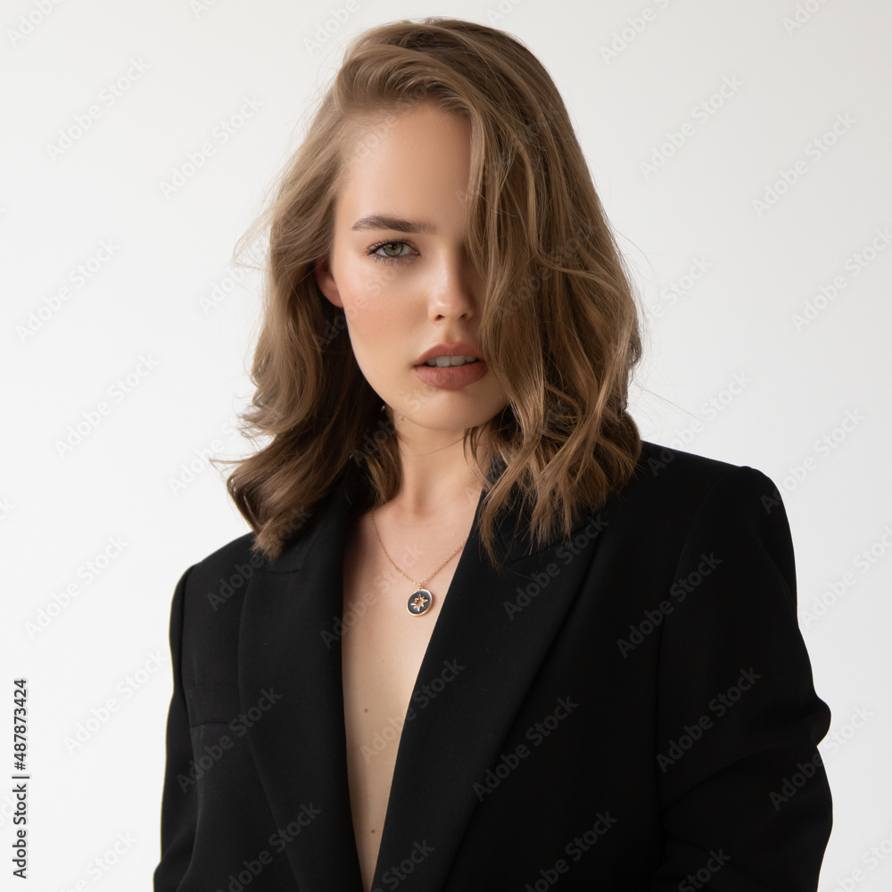 Natural look. Beauty model woman . Model test portrait with young beautiful fashion model posing on grey background. Blond woman in a black blazer . Natural makeup Natural look. Beauty model woman . Model test portrait with young beautiful fashion model posing on grey background. Blond woman in a black blazer . Natural makeup