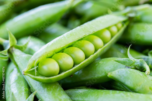 Green peas. Close up of green fresh peas and pea pods. Healthy vegetarian food, rich in natural protein