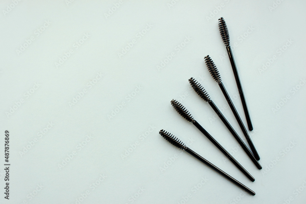 Eyelash brushes concept, mascara on blue background. mockup with copy space Eyelash brushes concept, mascara on blue background. mockup with copy space