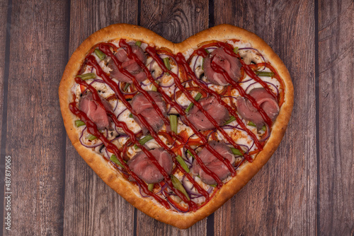 heart shaped pizza on wooden background for restaurant menu1 photo