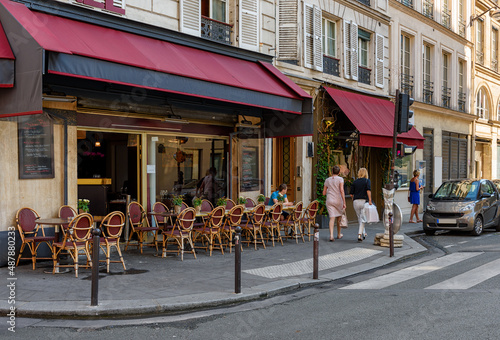 Typical view of street with tables of cafe in Paris, France. Cozy cityscape of Paris. Architecture and landmarks of Paris. © Ekaterina Belova