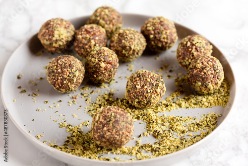  Date and nuts energy balls rolled in pumpkin seeds fine dust