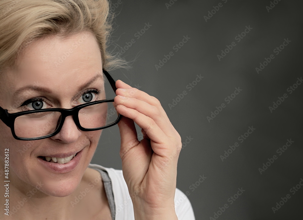 woman holding glasses on display with grey background stock photo woman holding glasses on display with grey background stock photo
