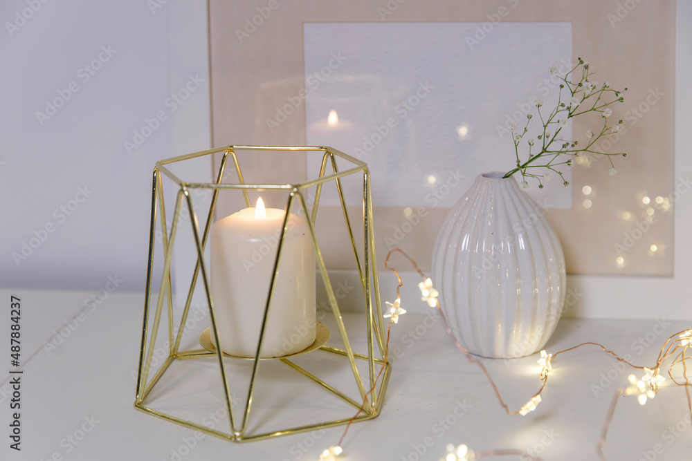 Two unopened hyacinths in a glass vase with artificial ice. Interior view in modern scandinavian style with painting canvas or poster on the wall. Living room, chest of drawers with vases. Two unopened hyacinths in a glass vase with artificial ice. Interior view in modern scandinavian style with painting canvas or poster on the wall. Living room, chest of drawers with vases.