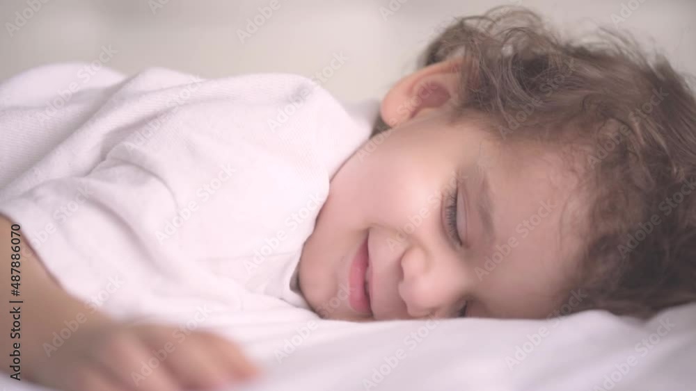 Little cute Caucasian child smiling in his sleep. Two years old toddler sleeping comfortably. Little cute Caucasian child smiling in his sleep. Two years old toddler sleeping comfortably.