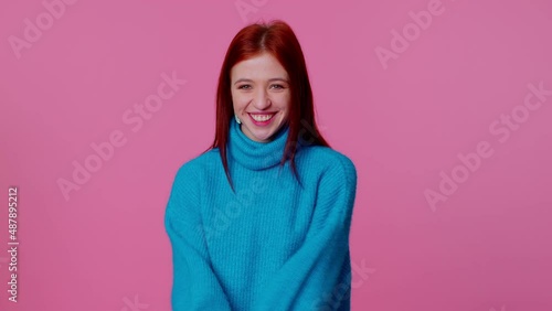 Wow. Hello, welcome. Portrait of happy excited young teenager girl appear from below waving hi with her palm, greeting with hospitable friendly smile. Indoor studio shot isolated on pink background