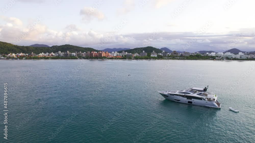 The yacht sails to the shore at sunset. The yacht sails to the shore at sunset.