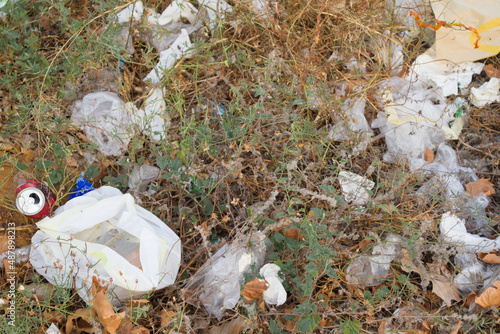 Garbage accumulated on the ground in which plants and rubbish are mixed