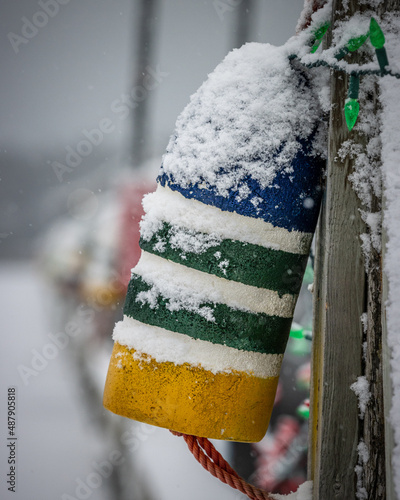 Buoy with snow on it in Winter. Christmas Lights, Shallow depth of field, blurry, out of focus, Canada Saint Andrews, New Brunswick