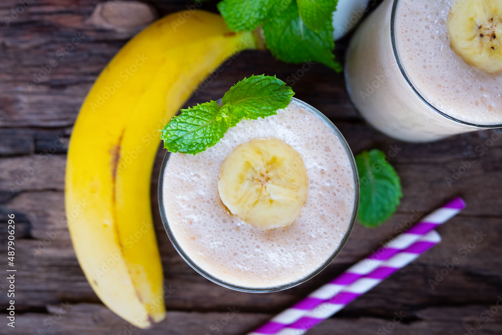Banana fresh cocktail vanilla smoothies fruit juice beverage healthy the taste yummy in glass drink episode good morning on wooden background from the top view. Banana fresh cocktail vanilla smoothies fruit juice beverage healthy the taste yummy in glass drink episode good morning on wooden background from the top view.