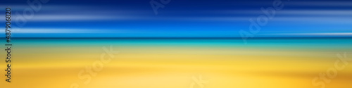 Panoramic view of the sandy beach of the sea, blurred summer background. Blue sky, sea and yellow sand.