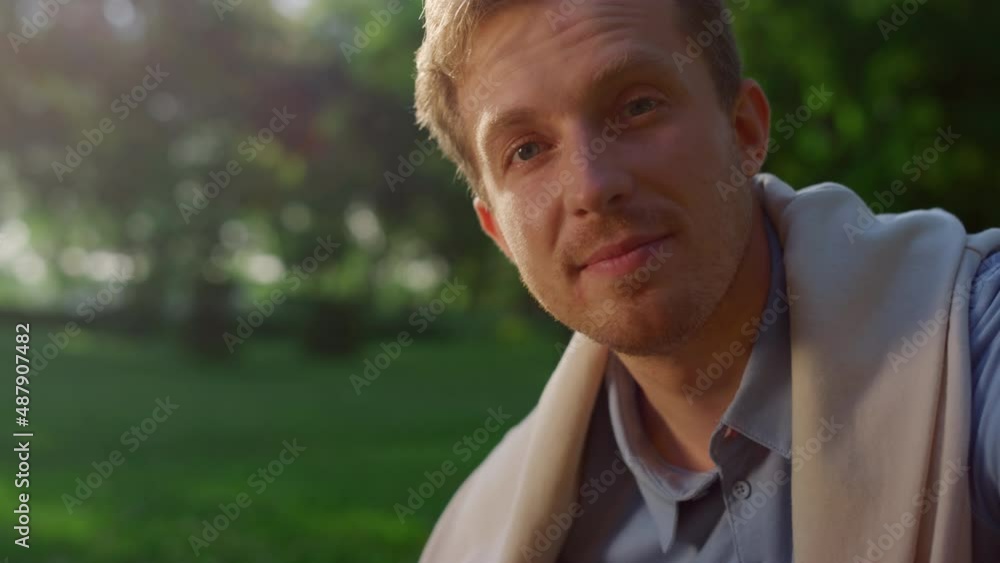 Closeup handsome blond man posing in sunlight. Smiling guy look in camera Closeup handsome blond man posing in sunlight. Smiling guy look in camera