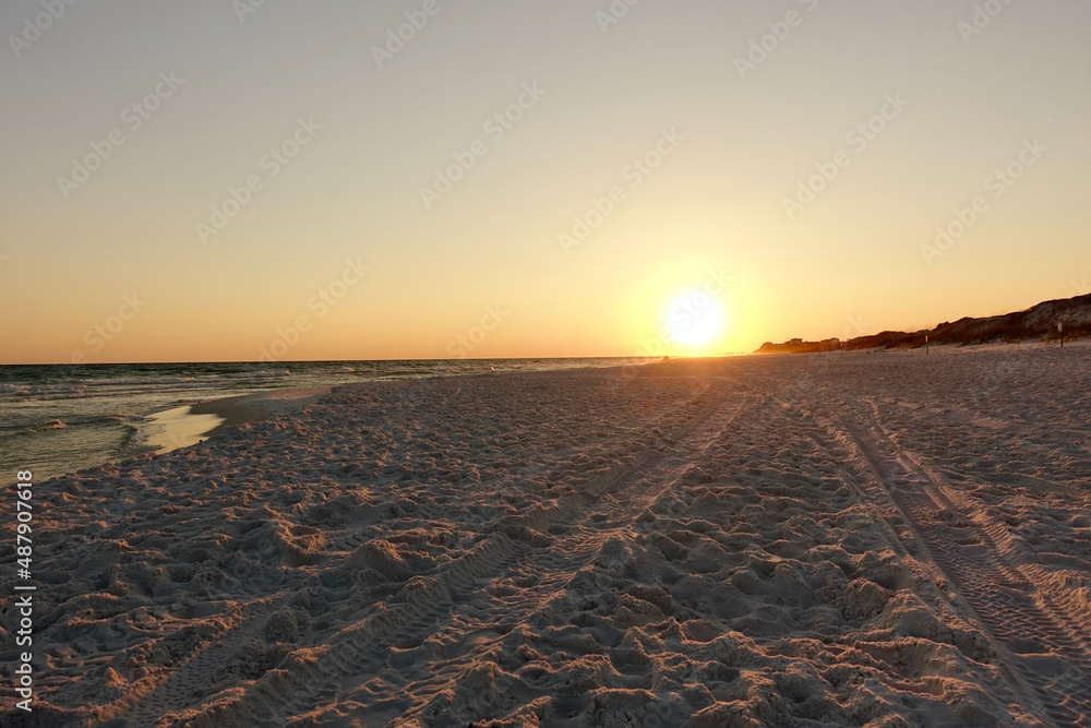 Sunset on the beach with tire tracks Sunset on the beach with tire tracks