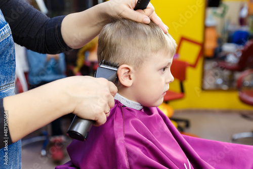 Children's haircut in a special children's barbershop.