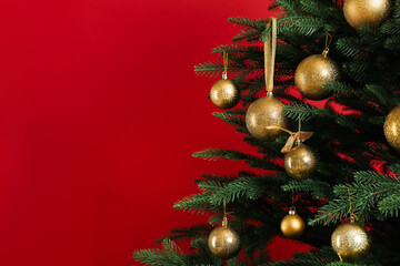 Beautifully decorated Christmas tree on red background, closeup. Space for text