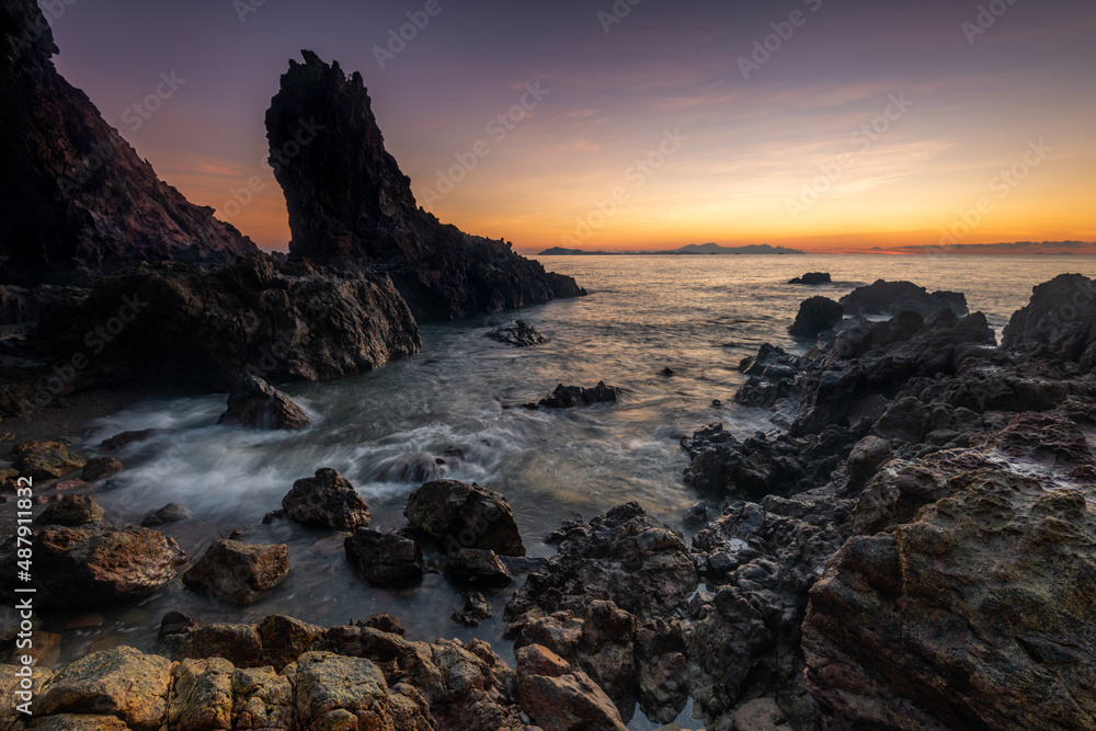 orange sunset on the beach with waves in Pulau Mawar, Mersing, Johor, Malaysia orange sunset on the beach with waves in Pulau Mawar, Mersing, Johor, Malaysia