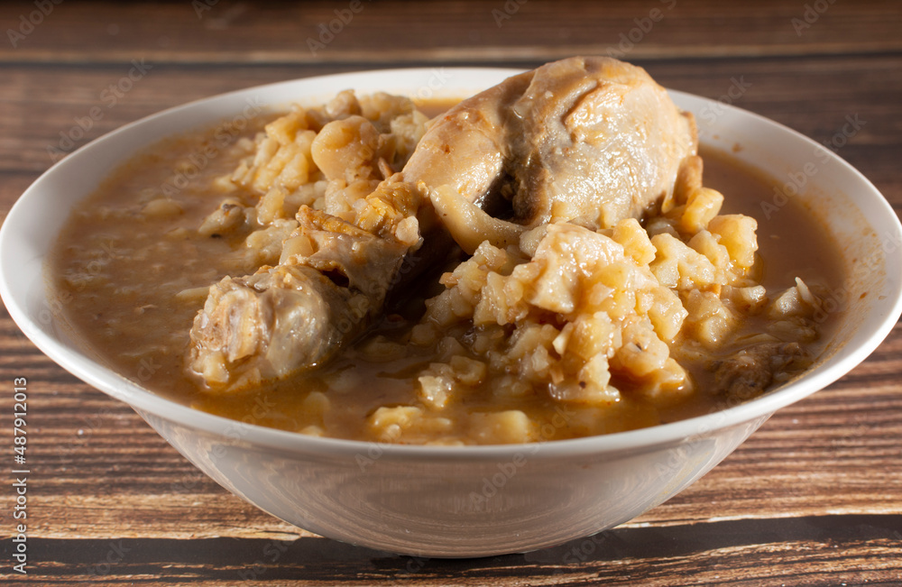 Chicken carapulcra on a plate on a wooden background Chicken carapulcra on a plate on a wooden background