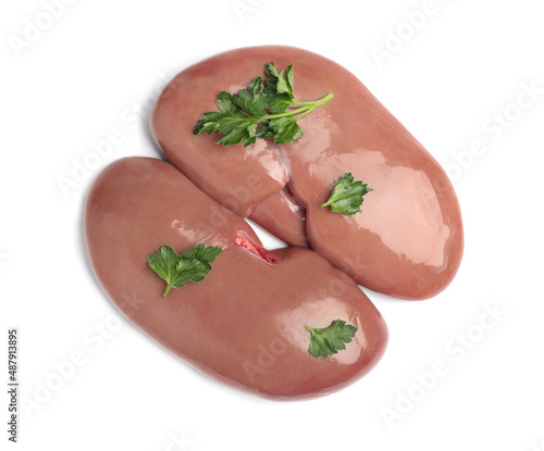 Fresh raw pork kidneys with parsley on white background, top view