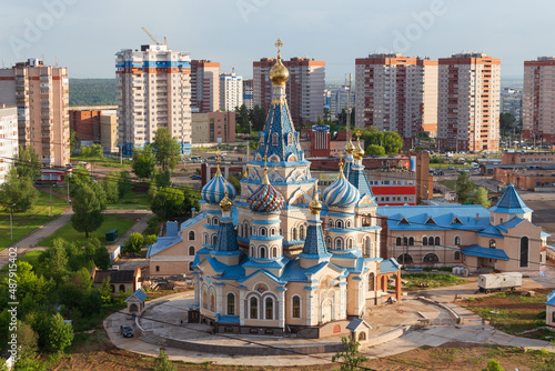beautiful blue church on the background of the city, background for a postcard, Izhevsk