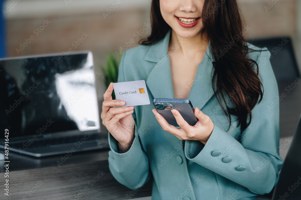 Online Shopping and Internet Payments, Beautiful Asian women are using their credit cards and mobile phones to shop online or conduct errands in the digital world. Online Shopping and Internet Payments, Beautiful Asian women are using their credit cards and mobile phones to shop online or conduct errands in the digital world.