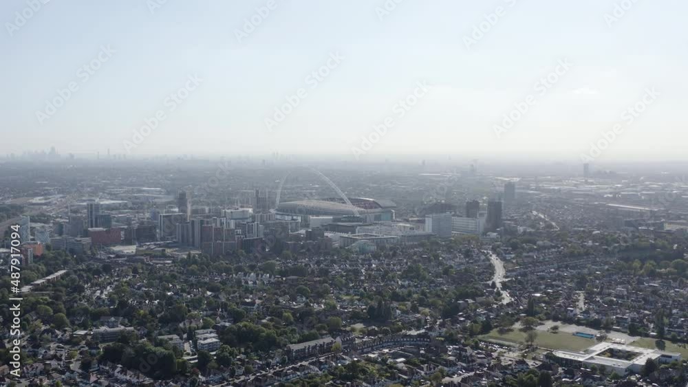 Rising aerial shot of Wembley Stadium from a distance as well as a sunny London skyline. Rising aerial shot of Wembley Stadium from a distance as well as a sunny London skyline.