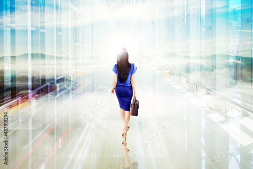 Businesswoman walking toward bright light