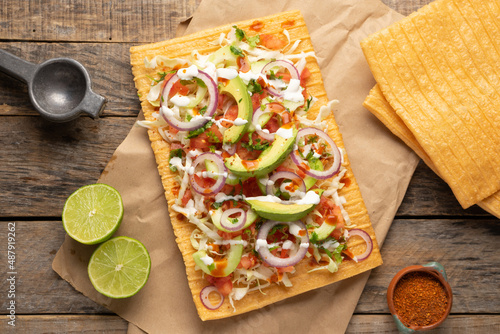 Snack made with wheat flour called chicharron preparado with sauce and vegetables. Mexican food