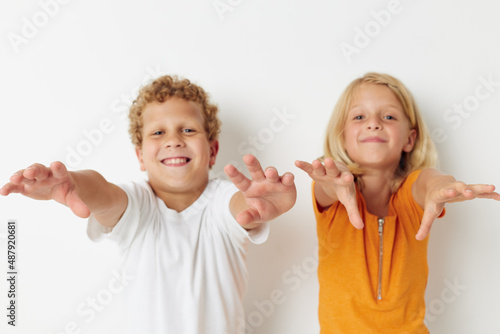 Boy and girl hand gestures fun childhood isolated background unaltered