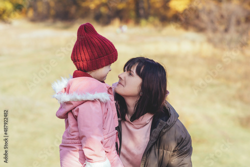 Happy and smilling mother and daughter in nature. Family, parenting and healthy relationship concept