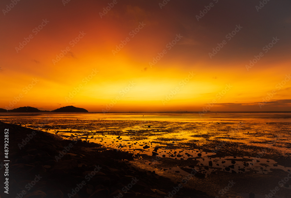 Scene of beautiful orange sky at Phuket beach