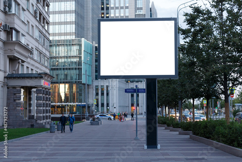 Billboard empty on the background of office buildings in the city. Mock-up.