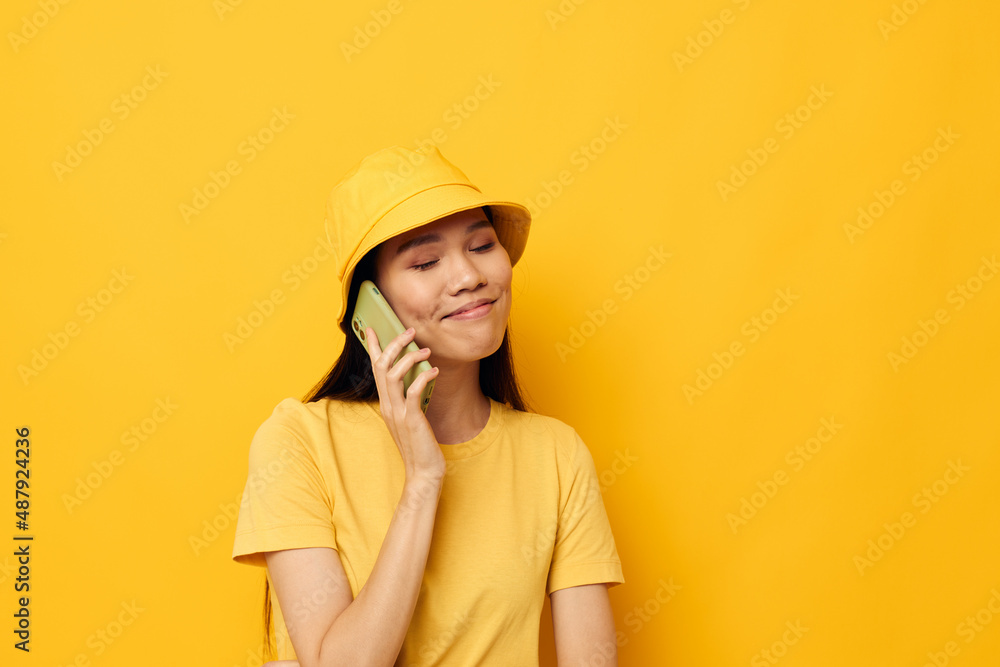 woman with Asian appearance holding a phone posing lifestyle technology isolated background unaltered woman with Asian appearance holding a phone posing lifestyle technology isolated background unaltered