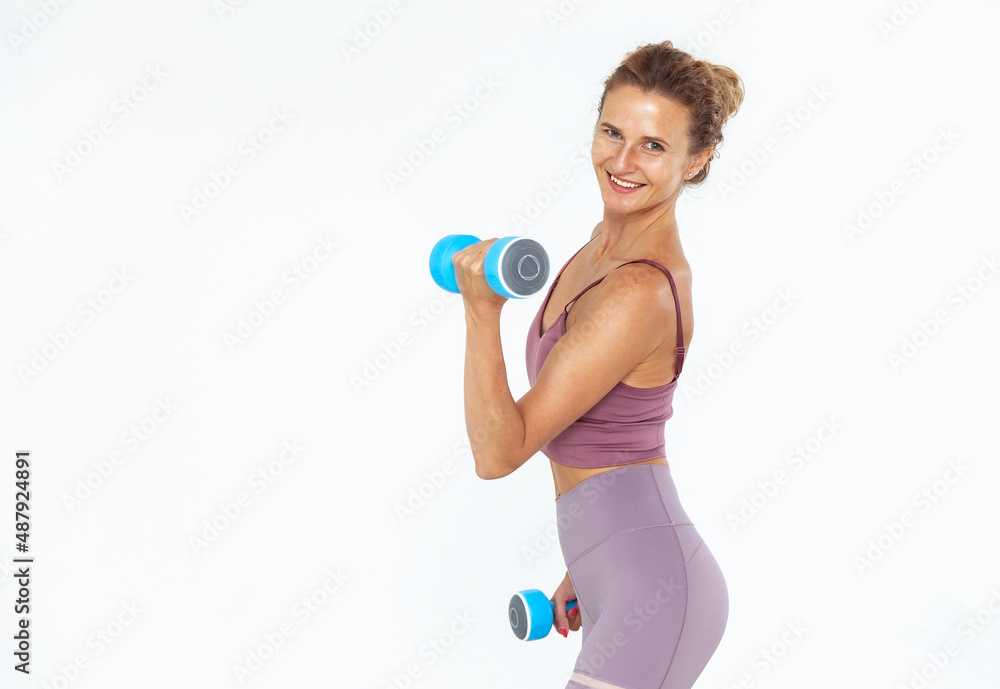 Portrait of healthy smiling fitness woman in sportswear holding dumbbell isolated on white background Portrait of healthy smiling fitness woman in sportswear holding dumbbell isolated on white background