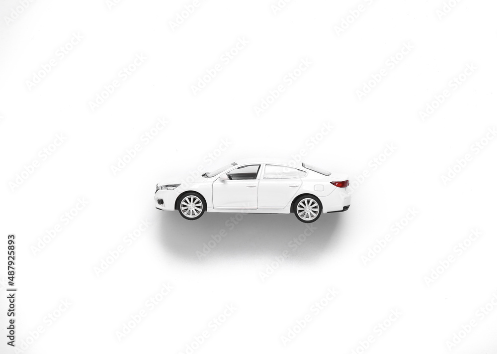 White toy car model against white background. Top view