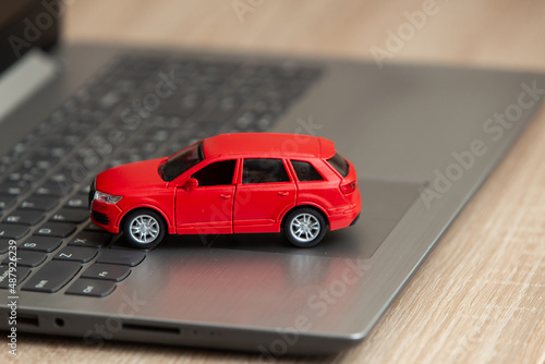 Toy car model on laptop on table © splitov27